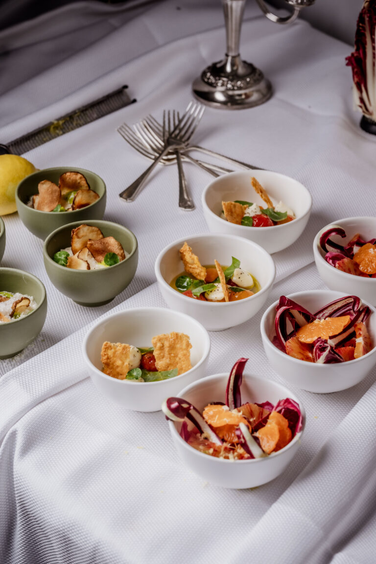 London gourmet canapés in small bowls: radicchio and orange salad alongside mozzarella caprese bites. Perfect canape catering for corporate events and private receptions.